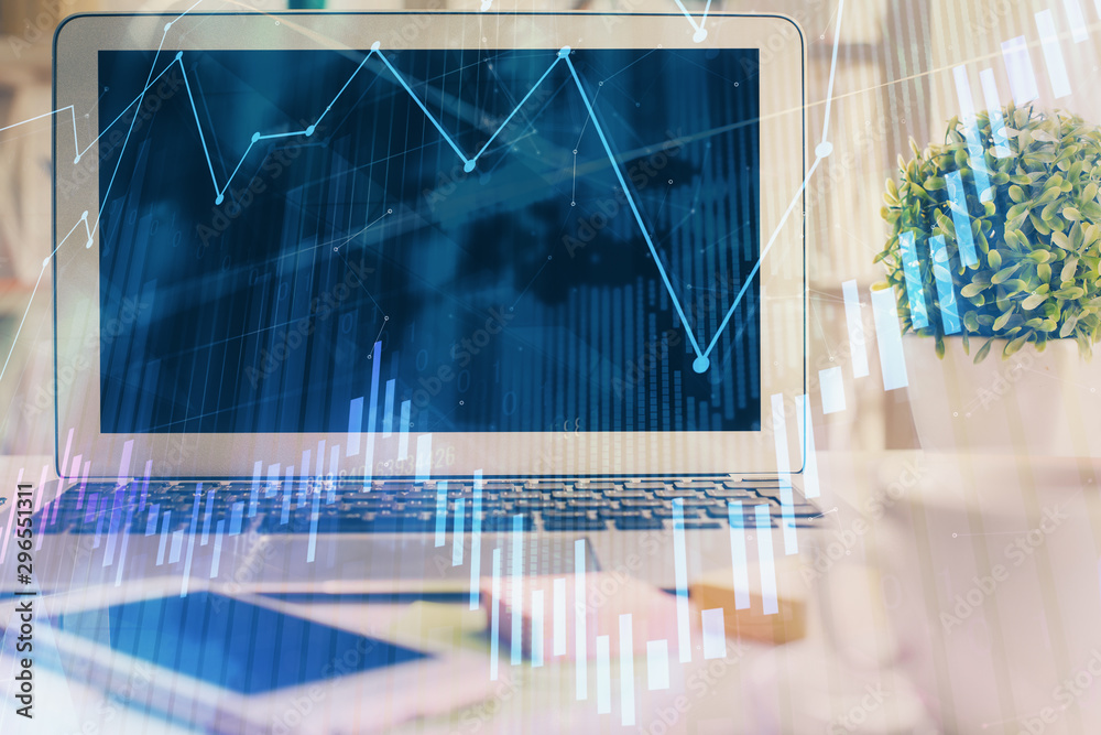 Forex market graph hologram and personal computer on background. Multi exposure. Concept of investment. Forex market graph hologram and personal computer on background. Multi exposure. Concept of investment.