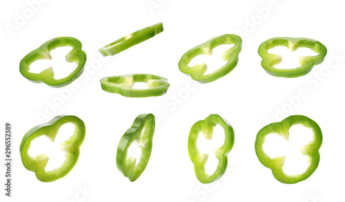 Set with slices of fresh green bell peppers on white background