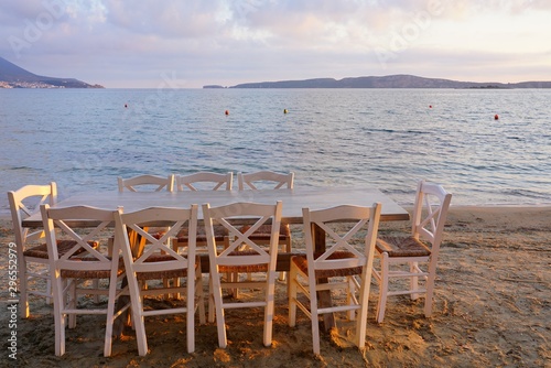 Table set on the beach at a traditional Greek taverna in Gialova on the Navarino Bay in Messinia in the Peloponnese region of Greece near Pylos