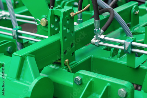 A fragment of the details of the mechanism of agricultural machinery close-up / abstract industrial technology background.