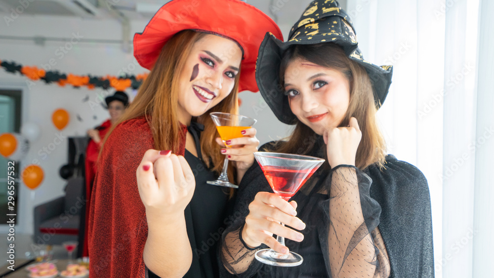 Halloween night 2 Beautiful young woman in witches hats and 1 man wizard costume in party Halloween be joyful music and drink spooky trick and treat Halloween night 2 Beautiful young woman in witches hats and 1 man wizard costume in party Halloween be joyful music and drink spooky trick and treat