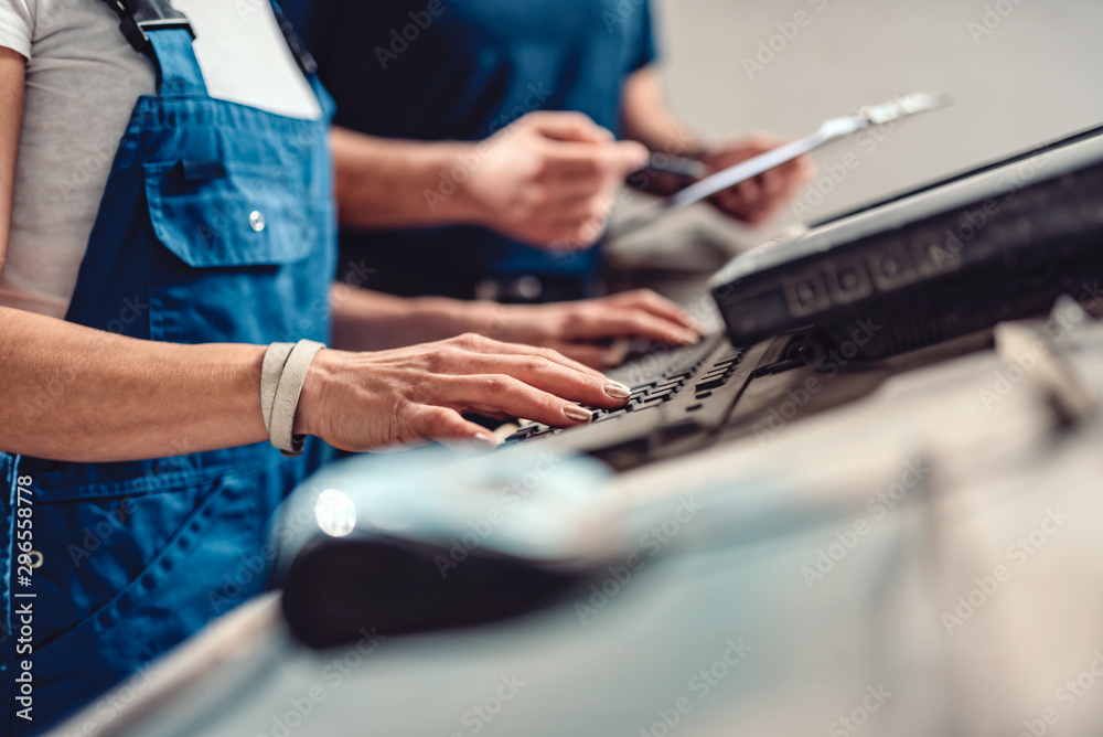 Female CNC operator write fabrication program on the computer