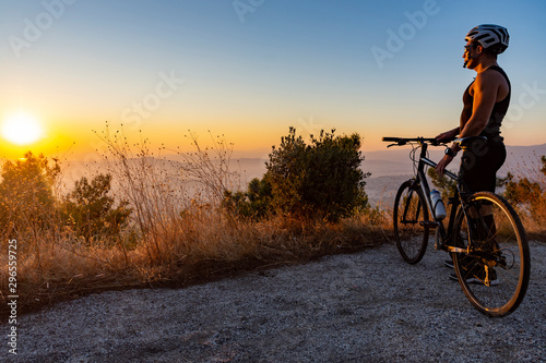 Male biker watching the sunset