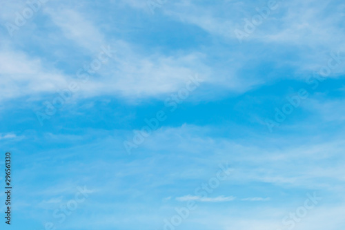 Blue sky with soft white clouds.