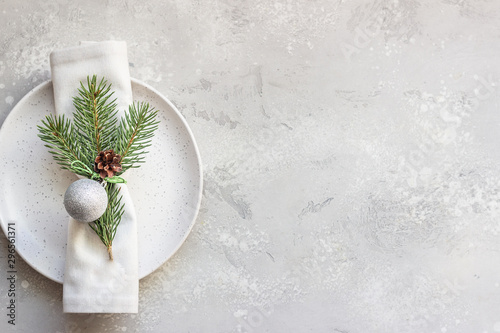 Christmas or New Year table setting with festive decorations on light grey background with copy space. Holidays background. Top view, flat lay. photo