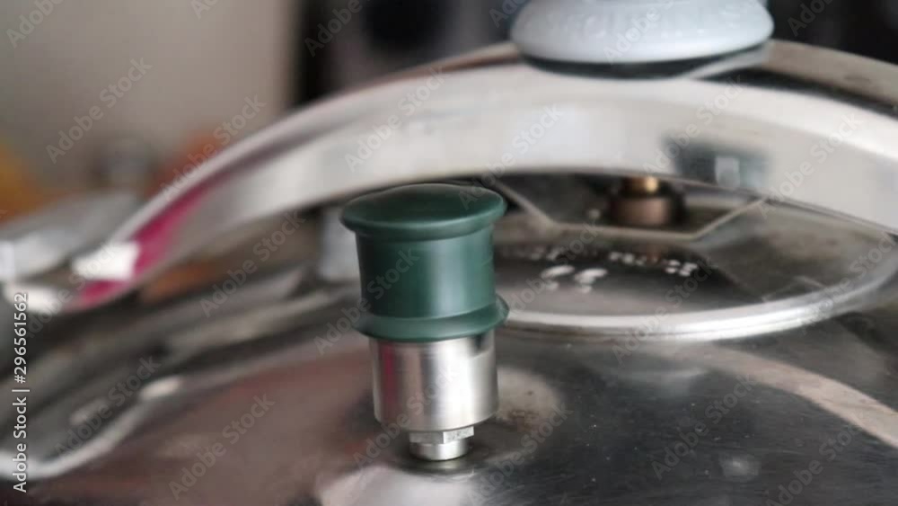 Steam pressure cooker venting steam in kitchen Steam pressure cooker venting steam in kitchen
