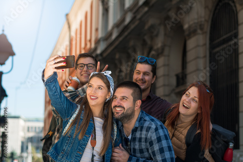Happy multiracial friends group taking selfie © Daniel