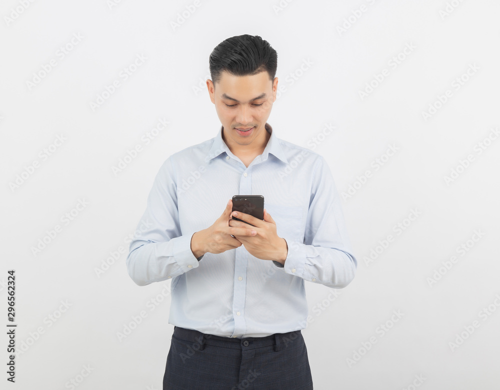 Young handsome asian business man playing smartphone with smiling isolated on white background. Young handsome asian business man playing smartphone with smiling isolated on white background.