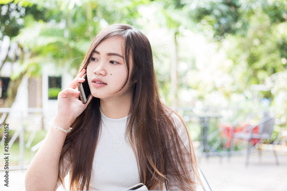 Business asian women use cellphone sitiing in coffee shop Business asian women use cellphone sitiing in coffee shop