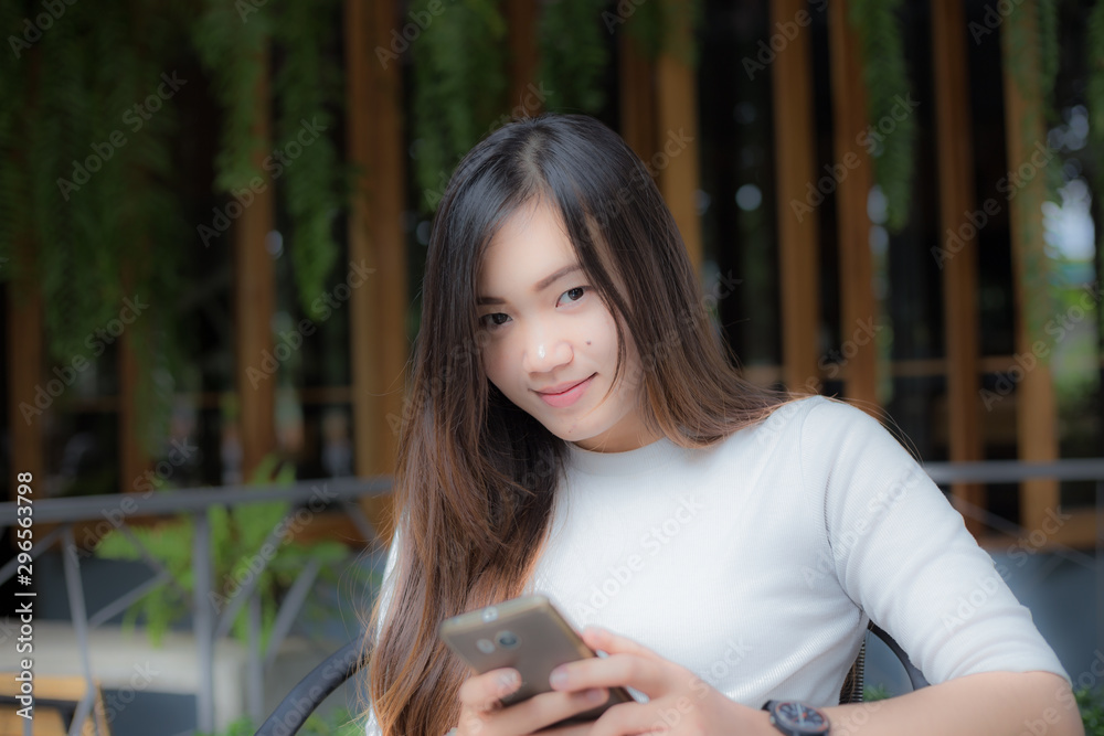 Business asian women use cellphone sitiing in coffee shop Business asian women use cellphone sitiing in coffee shop