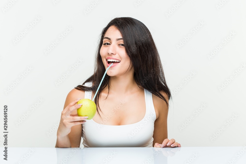 Young hispanic woman drinking an apple juice with a straw Young hispanic woman drinking an apple juice with a straw