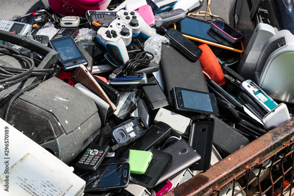 Close up on pile broken cell phones and electronic devices at an electonic waste centre Close up on pile broken cell phones and electronic devices at an electonic waste centre