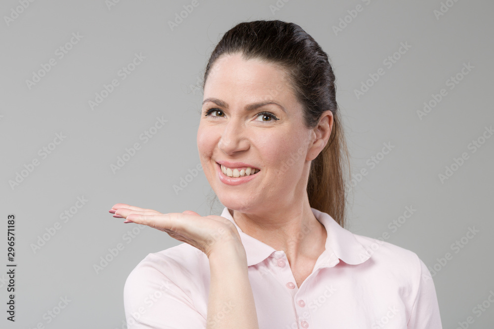 smiling mid age woman shows emotional expressions with her hands smiling mid age woman shows emotional expressions with her hands