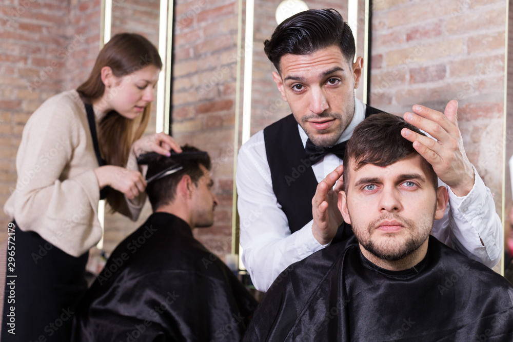 Male discussing haircut with hairdresser