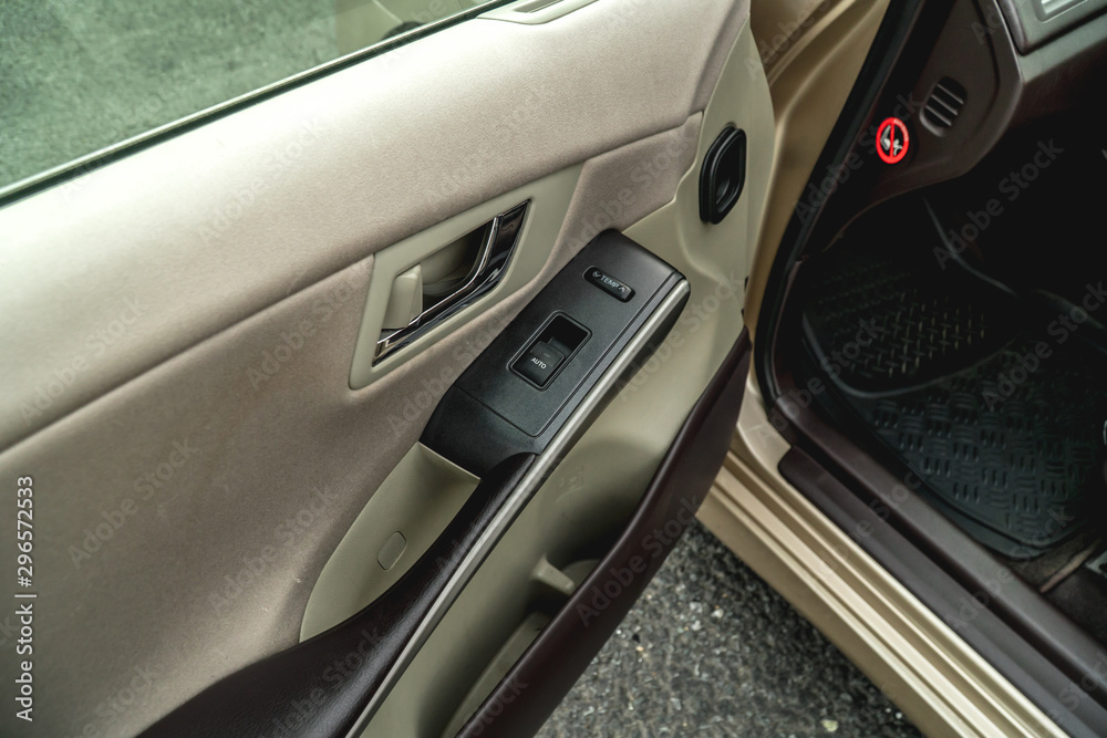 Photo of car doors with buttons to adjust the height of glasses