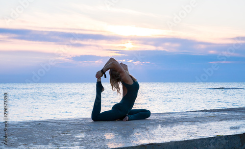 Photography unrecognizable senoir woman with beautiful body doing yoga splits at sunrise on