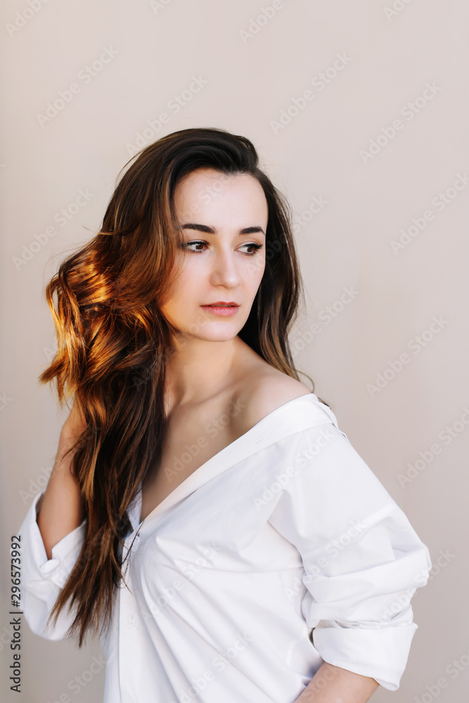 portrait of a young beautiful woman with dark hair. Beautiful young brunette posing in the studio. Romantic shot portrait of a young beautiful woman with dark hair. Beautiful young brunette posing in the studio. Romantic shot