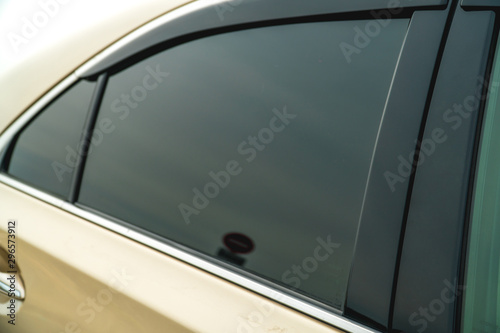 Photo of the darkened glass on the gold car