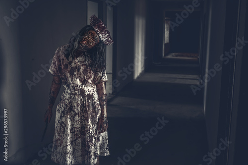 Ghost nurse woman or zombie holding the knife with resentment and malice in the building abandoned hospital.