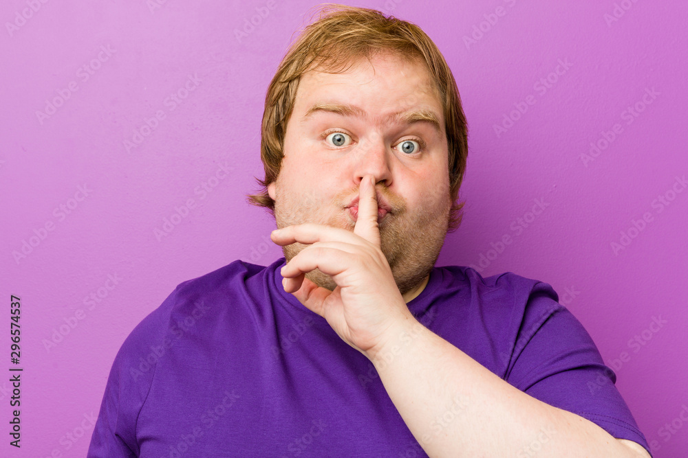 Young authentic redhead fat man keeping a secret or asking for silence.