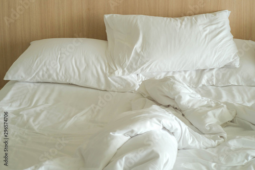Messy white bed and pillows in the morning