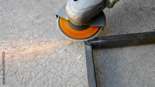 Processing sharp edges on the metallic article with grinding wheel photo