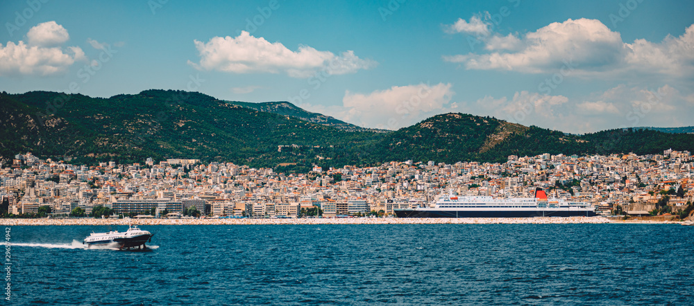 Kavala cityscape with cruise ship and hydrofoils boat at water