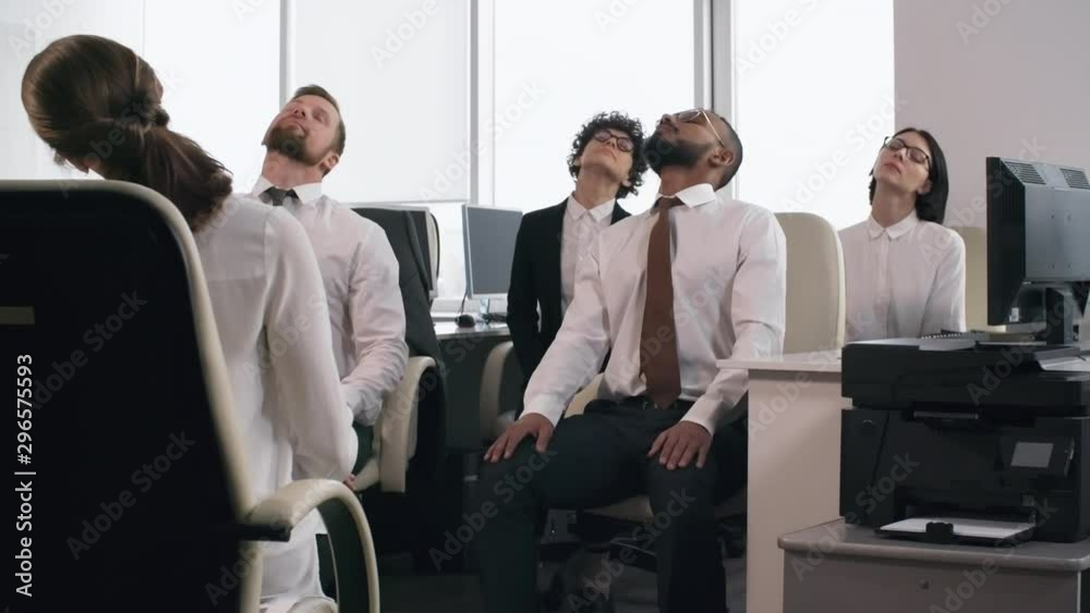 Group of diverse businesspeople sitting on office chairs with closed eyes and doing relaxing exercises together