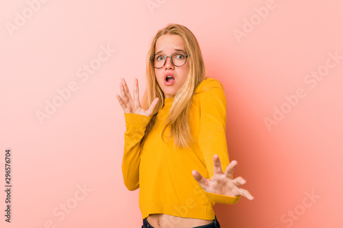 Adorable teenager woman being shocked due to an imminent danger