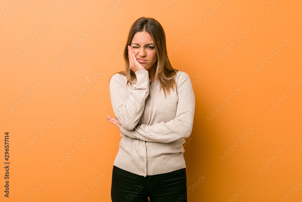 Young authentic charismatic real people woman against a wall who is bored, fatigued and need a relax day. Young authentic charismatic real people woman against a wall who is bored, fatigued and need a relax day.
