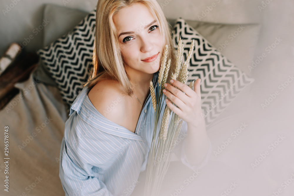 Portrait of a young beautiful woman in bed in the morning at home. Blonde girl in scandinavian interior. Good morning. Lifestyle. Portrait of a young beautiful woman in bed in the morning at home. Blonde girl in scandinavian interior. Good morning. Lifestyle.