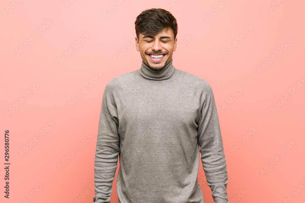 Young smart student man laughs and closes eyes, feels relaxed and happy. Young smart student man laughs and closes eyes, feels relaxed and happy.