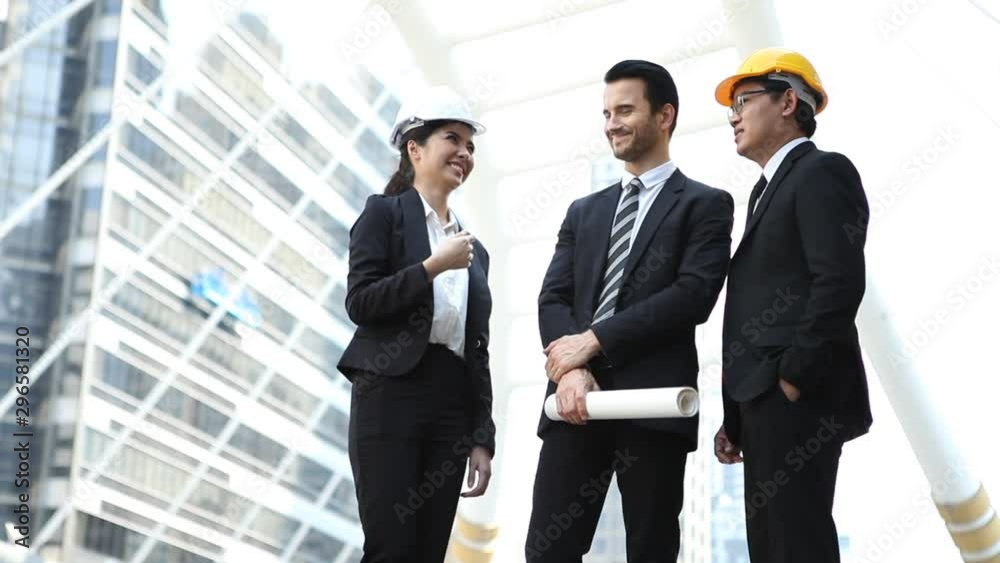 business man holding the blueprint discussion with architects and Construction engineers at construction site or building site at city outdoors group of businesspeople discussing outside . teamwork. business man holding the blueprint discussion with architects and Construction engineers at construction site or building site at city outdoors group of businesspeople discussing outside . teamwork.