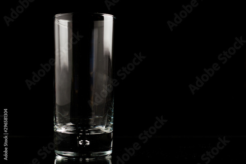 A glass of beer in a black scene