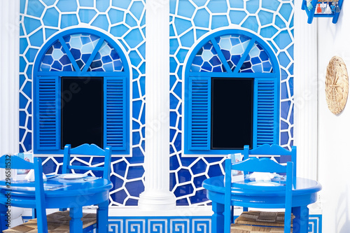 Fototapeta Naklejka Na Ścianę i Meble -  Greece style restaurant. Greek style decoration in blue and white. Inside the window is black screen that can insert photo , text or your personalized content.
