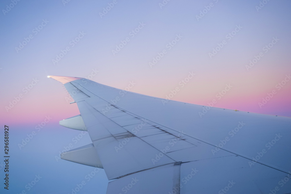 Wing of Airline against the beautiful twilight blue sky. Slightly grained effect.