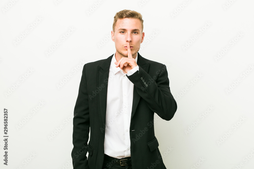 Young caucasian business man keeping a secret or asking for silence. Young caucasian business man keeping a secret or asking for silence.