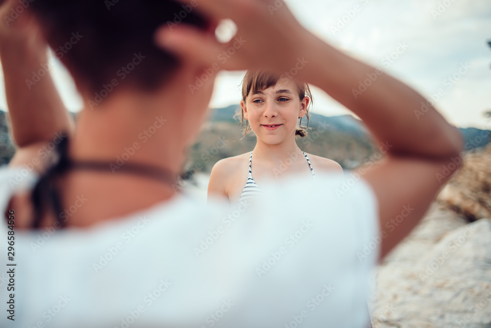 Daughter talking with her mother on the beach