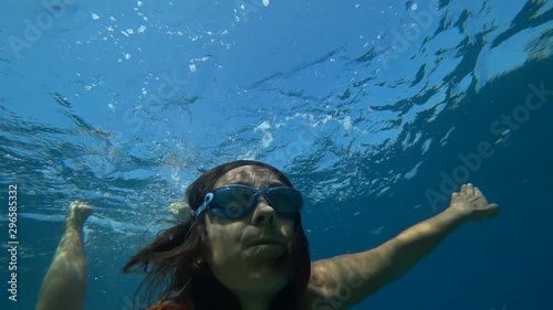 Kekova, Turkey - 30th of September 2019: 4K Selfie Woman turns over and soars in the colorful sea waters photo