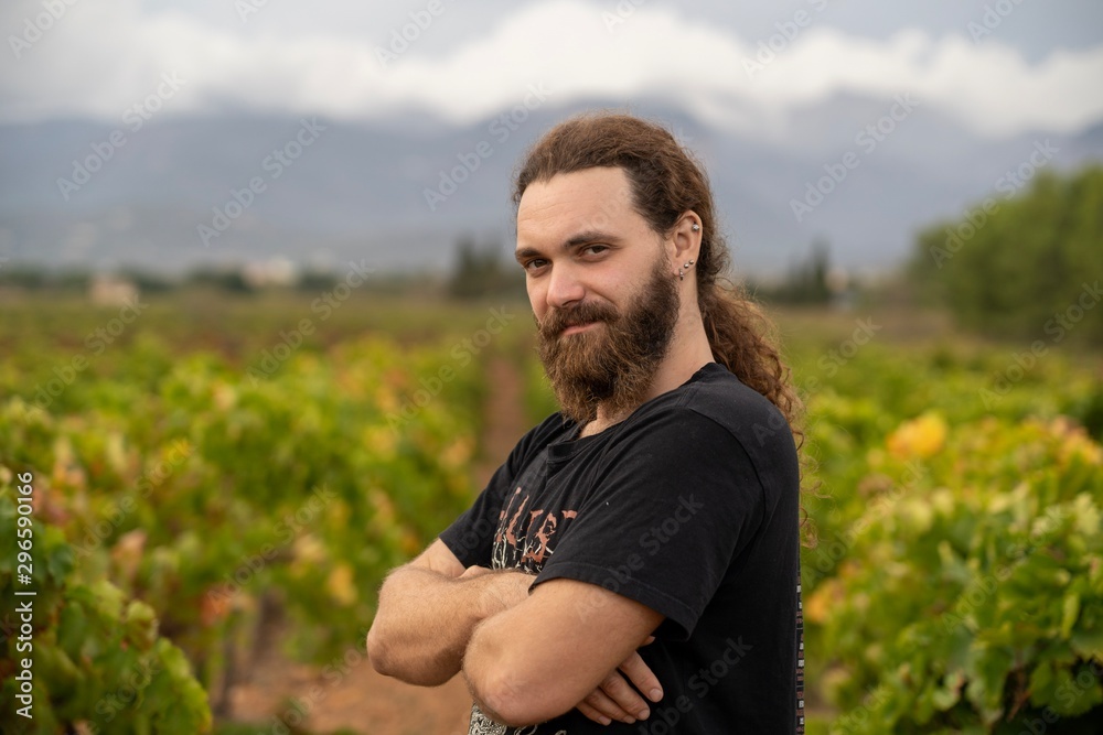 Master of wine posing in the middle of his vineyards where he produce wine