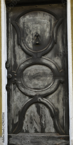 A view of an ancient door color silver, typical in old houses in Piedmont.