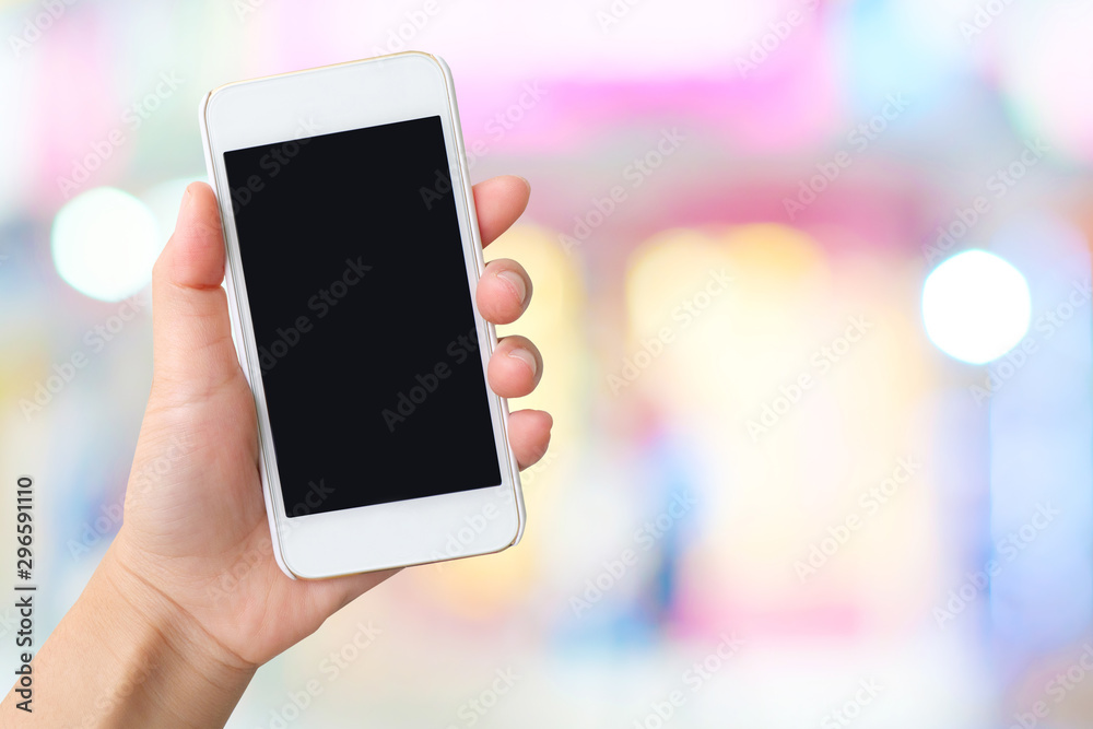 hand holding smart phone with blank screen isolated on white