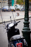 Black scooter with lamppost in the background