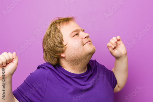 Young authentic redhead fat man dancing and having fun.