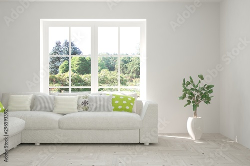 Stylish room in white color with sofa and summer landscape in window. Scandinavian interior design. 3D illustration © AntonSh