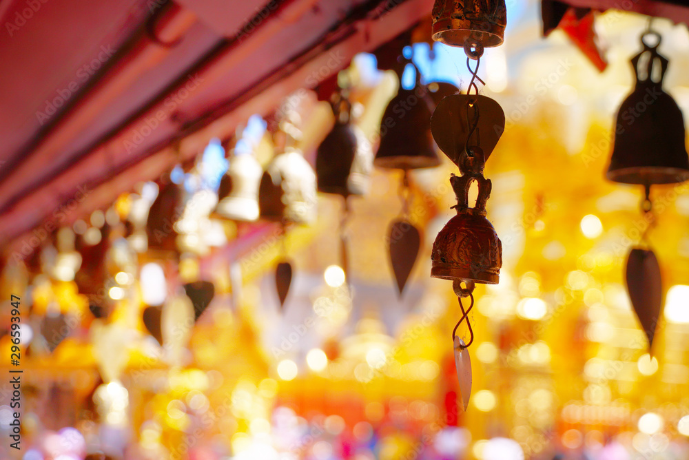 Fototapeta premium Small bells hang on roof in the temple with background gold pagoda