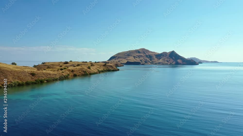 Aerial view of the coast of Komodo Island in Indonesia. This island is the only natural habitat of the endangered Komodo Dragon which is the world's largest lizard. Drone slow pan left to right Aerial view of the coast of Komodo Island in Indonesia. This island is the only natural habitat of the endangered Komodo Dragon which is the world's largest lizard. Drone slow pan left to right