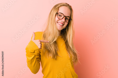 Adorable teenager woman person pointing by hand to a shirt copy space  proud and confident