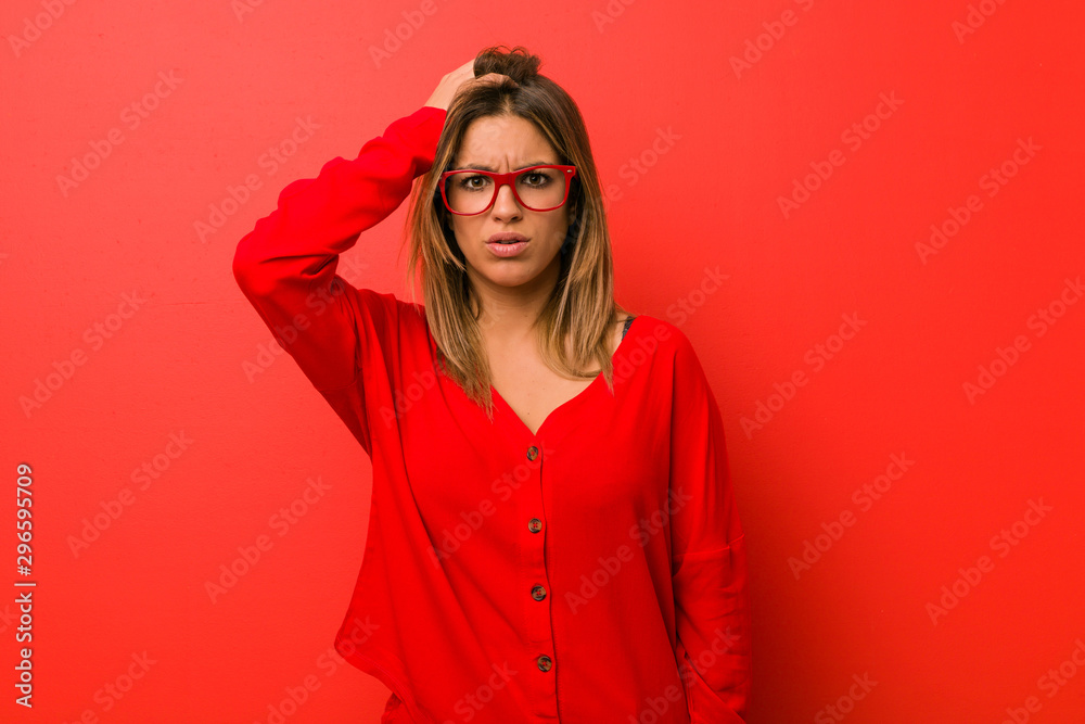 Young authentic charismatic real people woman against a wall being shocked, she has remembered important meeting. Young authentic charismatic real people woman against a wall being shocked, she has remembered important meeting.
