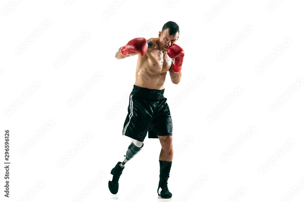 Full length portrait of muscular sportsman with prosthetic leg, copy space. Male boxer in red gloves. Isolated shot on white studio background. Full length portrait of muscular sportsman with prosthetic leg, copy space. Male boxer in red gloves. Isolated shot on white studio background.